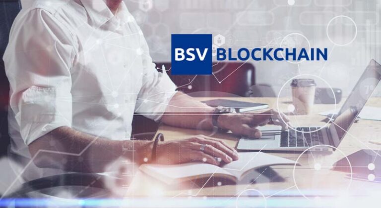 Man sitting infront of a laptop with Bsv blockchain logo overlat